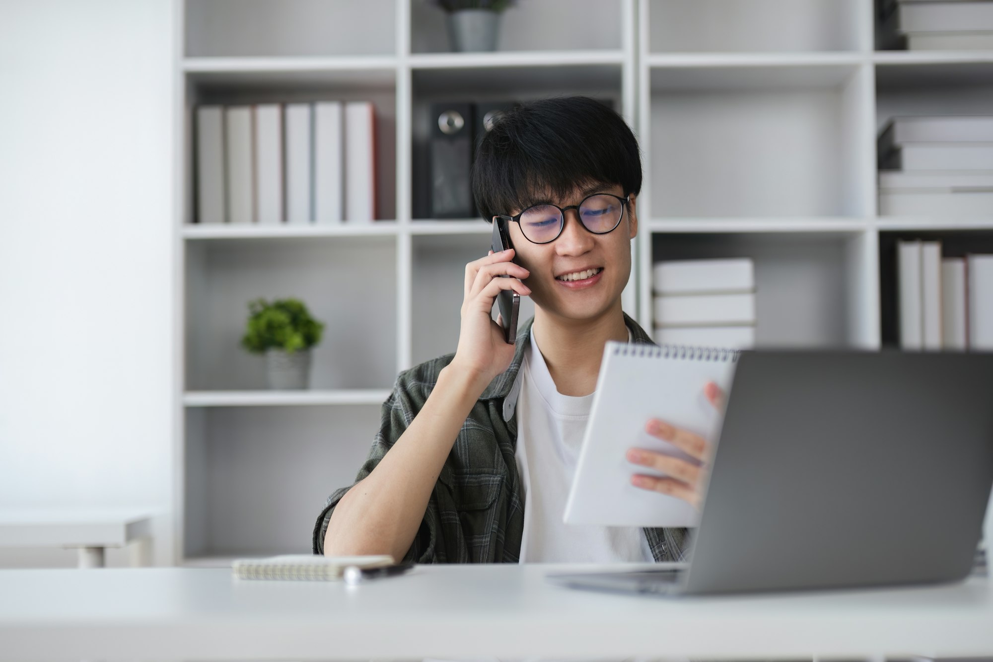 Young Asian man uses laptop to work on financial management. Financial transactions and use of